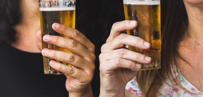 two women drinking beer